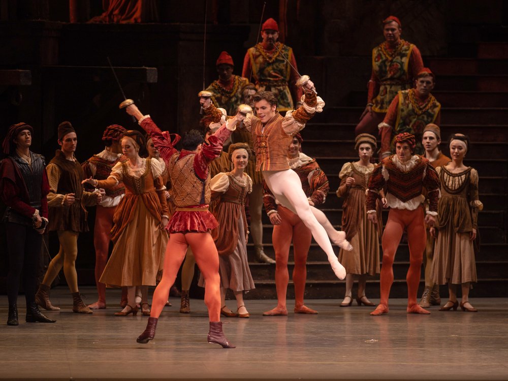 A ballet dancer leaps on the stage