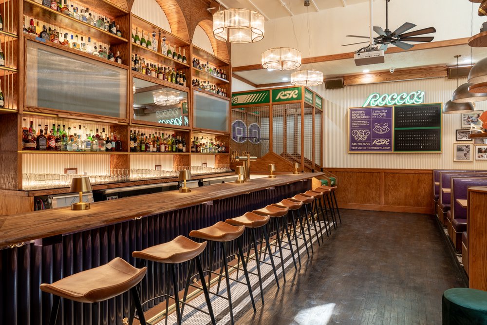 A row of chairs tucked into a bar.
