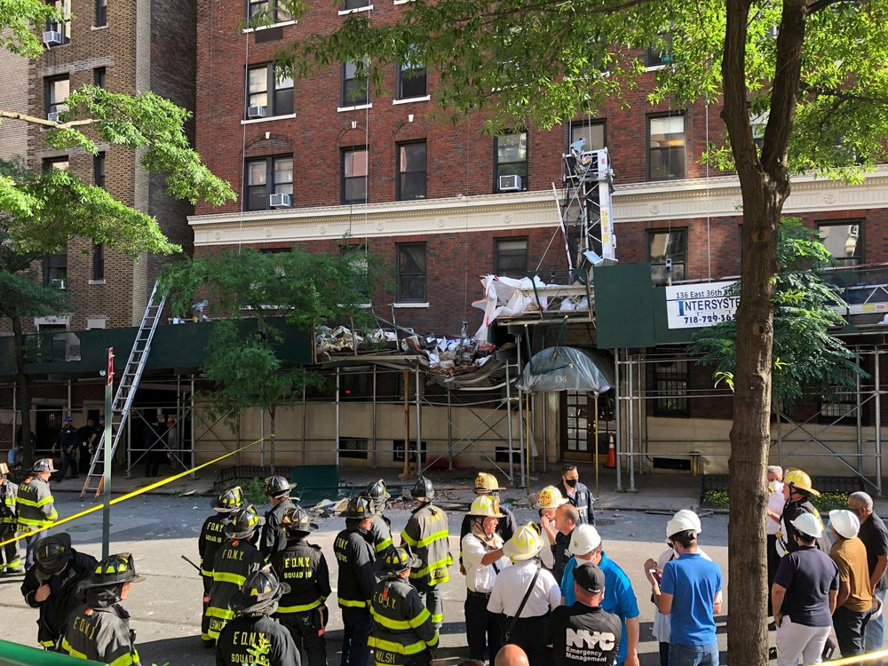 Emergency personnel work the scene of a scaffold collapse that left one worker dead and three others injured in Murray Hill.