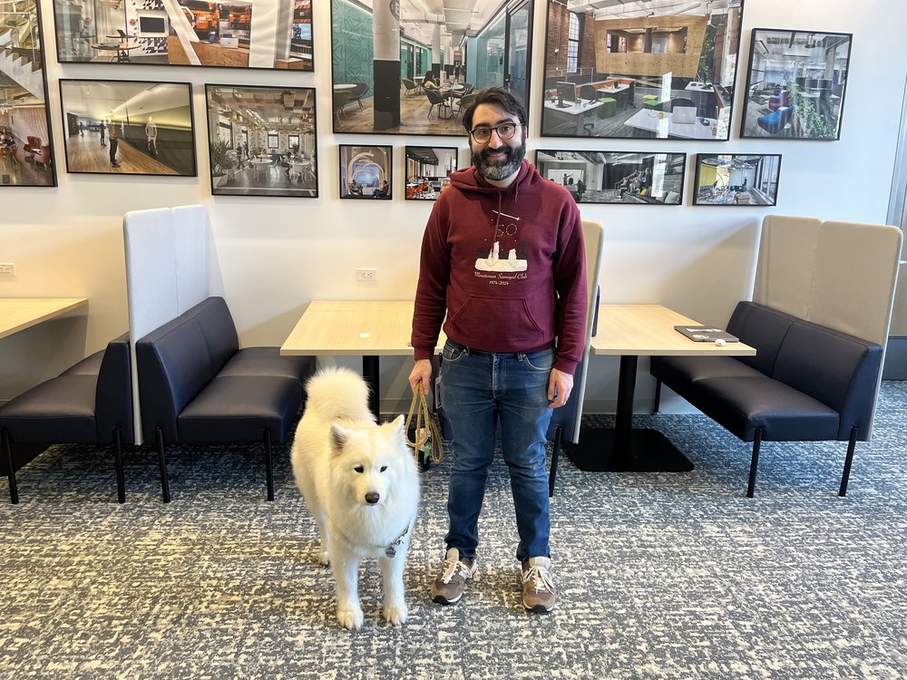 A man and his fluffy white dog.