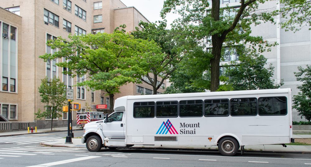 A van drives by a building