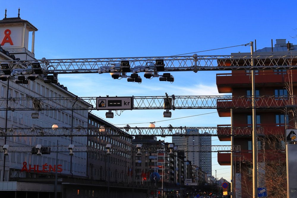 Traffic cameras above a street.