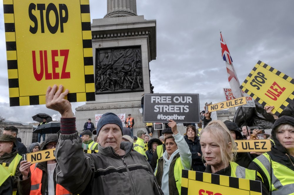 Protesters holding signs reading "Stop the ULEZ."