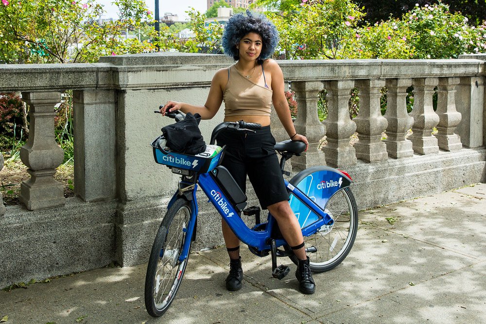 A woman rides takes a break from riding her Citi Bike on Memorial Day Weekend, 2020. The program got off to a shaky start one decade ago.