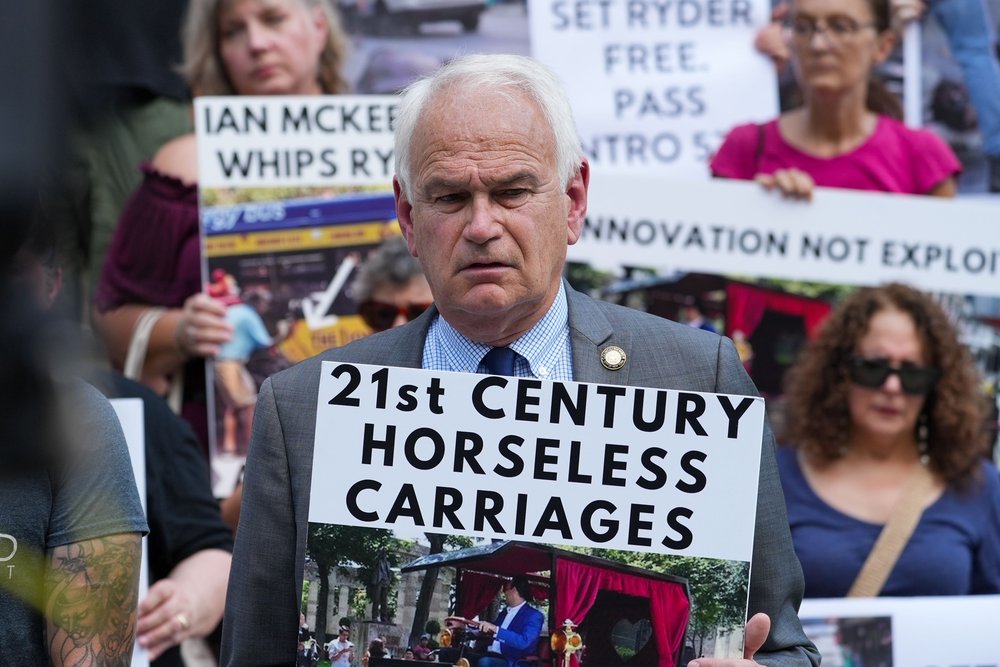 NYC Council member Robert Holden and members of animal rights group hold a protest against the horse carriage industry following the collapse of carriage horse Ryder on August 24th at City Hall.