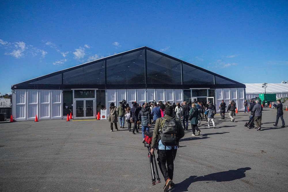 Members of the media assemble outside the Humanitarian Emergency Response and Relief Center on Randall's Island.