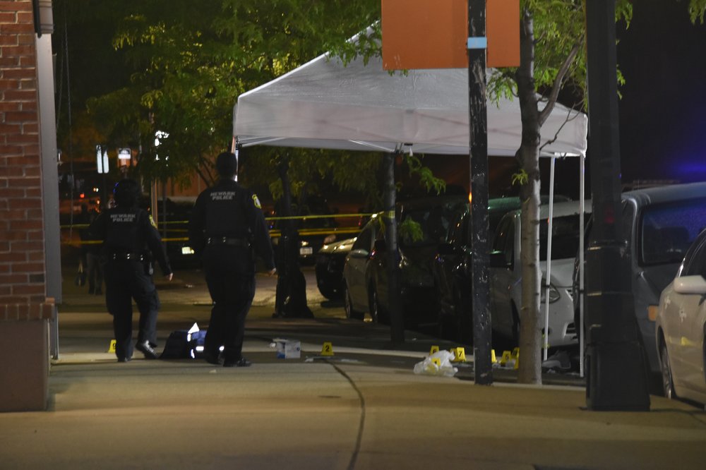 Police say officers found a man and boy both fatally shot at a Newark home Wednesday evening. Officers also chased and fatally shot a man who ran from the scene with a gun, according to the state Attorney General's Office.