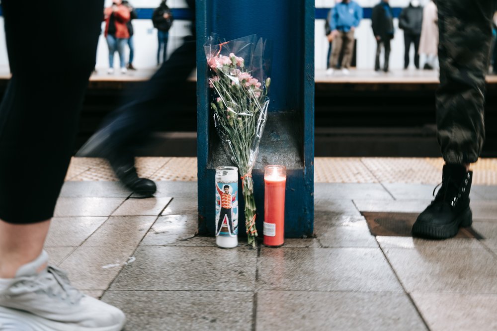 People walk past a makeshift memorial to Jordan Neely.