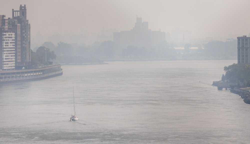 A sailboat on a hazy East River as smoke from wildfires burning in Canada continues to create unhealthy air quality conditions in New York.
