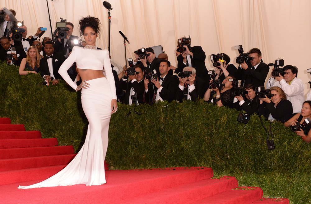 Rihanna in a cropped long sleeved white top and long white skirt, designed by Stella McCartney, at the 2014 Met Gala