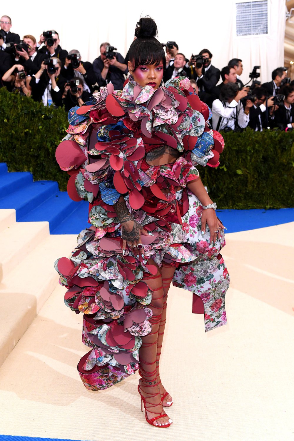 Another view of Rihanna in the layered 3D dress by Comme des Garcons at the 2017 Met Gala. She is also wearing high heels with laces that go up her legs.