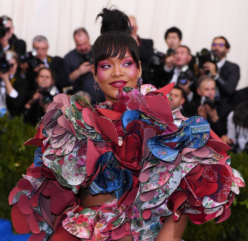 In a colorful red, floral, and blue 3d dress by Comme des Garcons