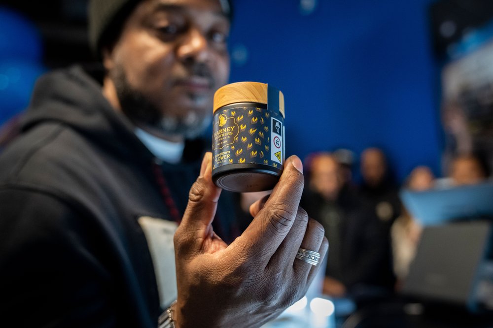 Roland Conner holds up a canister of cannabis flowers at his business Smacked in Lower Manhattan, Jan. 24, 2023. The store is the first Conditional Adult-Use Retail Dispensary (CAURD) opening since the legalization of cannabis that is run by businesspeople who had been impacted previously by cannabis prohibition.