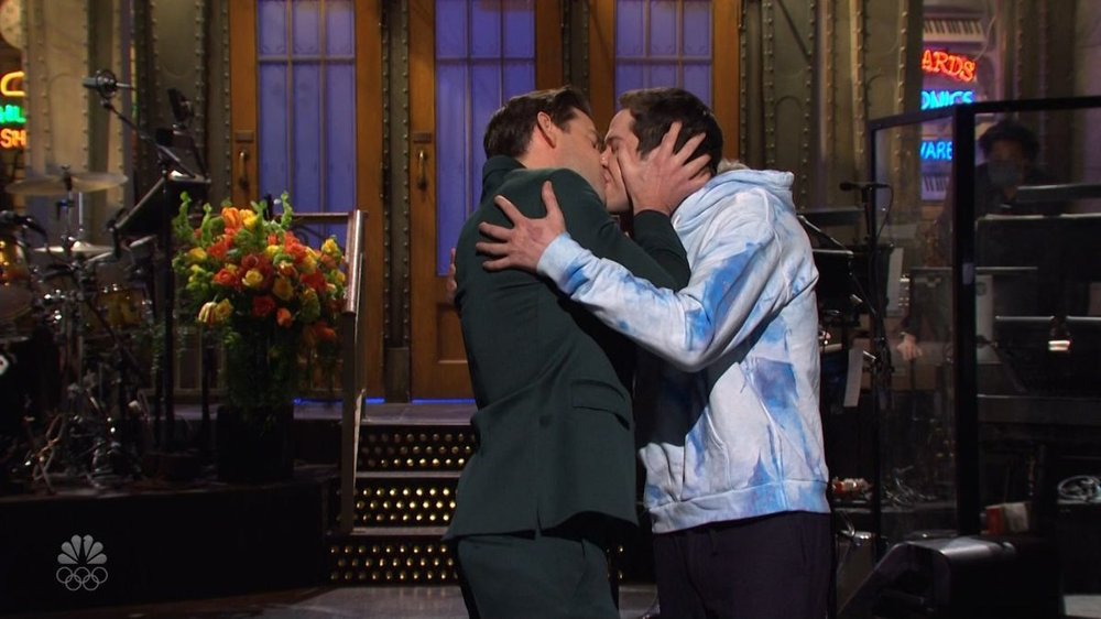John Krasinksi and Pete Davidson kissing during the SNL monologue