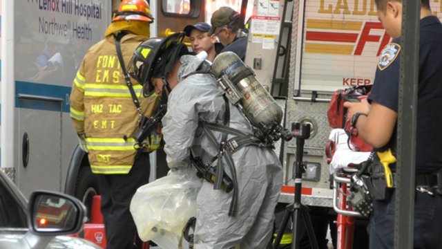 A firefighter in a hazmat suit on 61st Street this morning