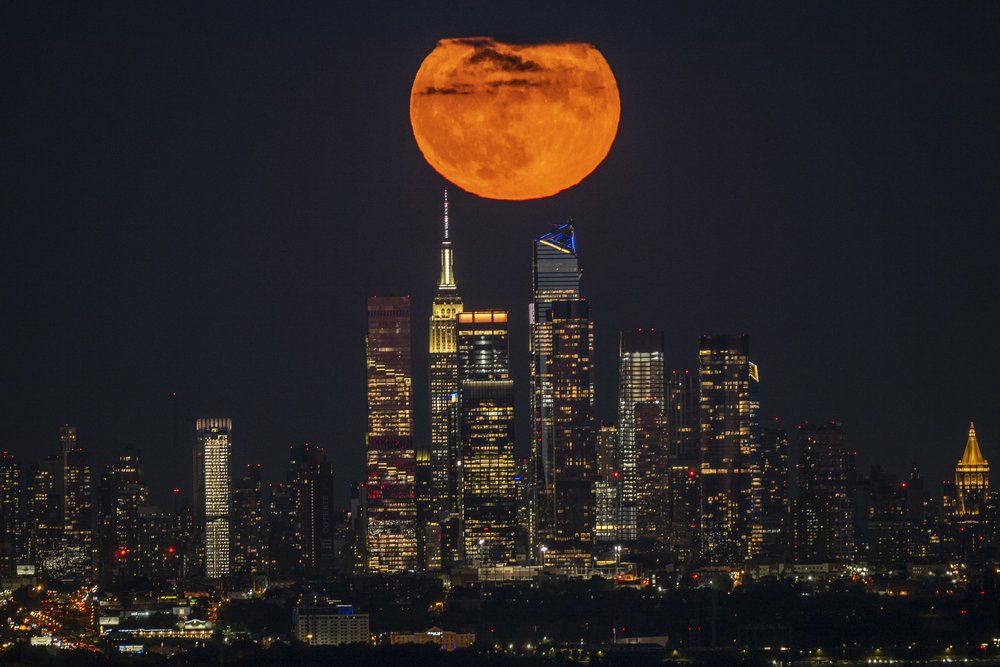 A "supermoon" rises over the Empire State Building in New York City, Aug. 1, 2023