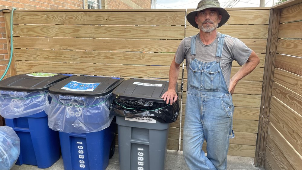 David Selig bought bins for his Rockaway rental properties, but they soon vanished. Here, he proudly stands next to some of his cans that haven't been stolen.
