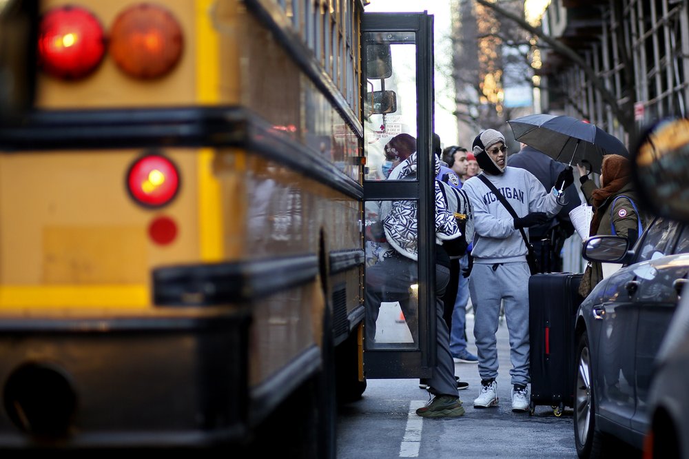 Migrants leave the camp in front of the Watson Hotel after being evicted, Feb. 1, 2023