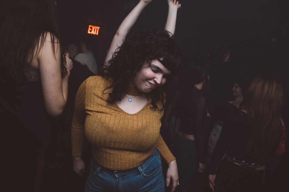 A woman dances at a club.