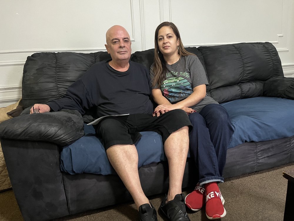 Victor Quiñones with his daughter Barbara Quiñones-Wallace in Victor’s apartment. Victor worked in maintenance at Maimonides Medical Center for 42 years before retiring in 2018. Barbara works currently as an office manager for the hospital.