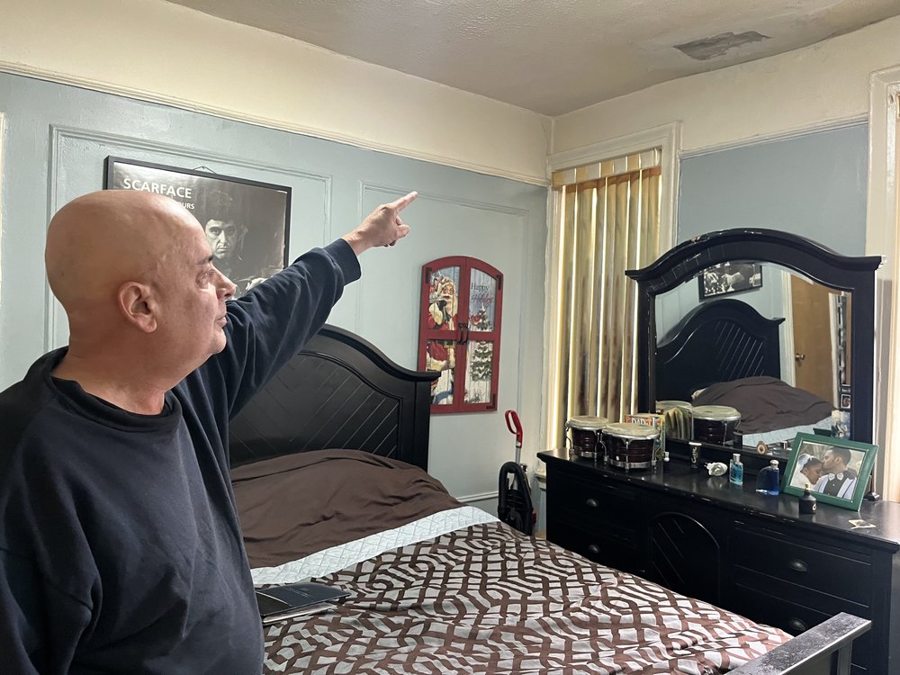 Victor Quiñones points to a spot on his bedroom ceiling where he once had a leak. He said Maimonides is slow to respond to requests for repairs and he often fixes things himself.