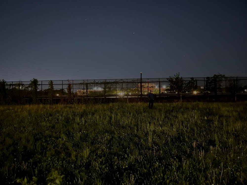 The grassy banks on the Jerome Reservoir in the Bronx at night.