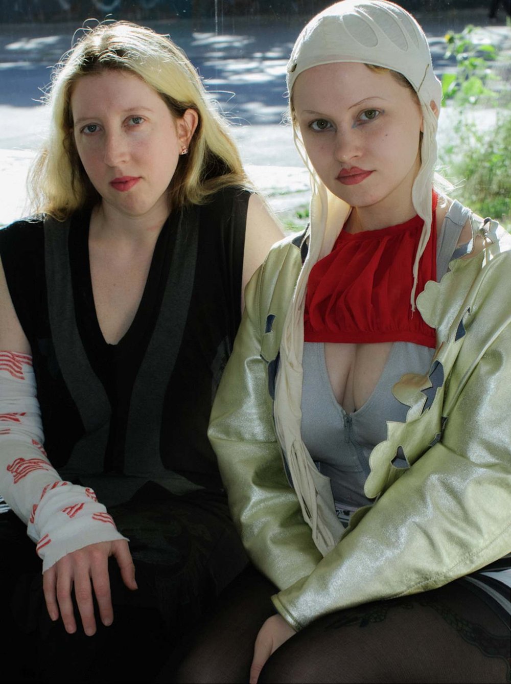 Two women pose for a camera.