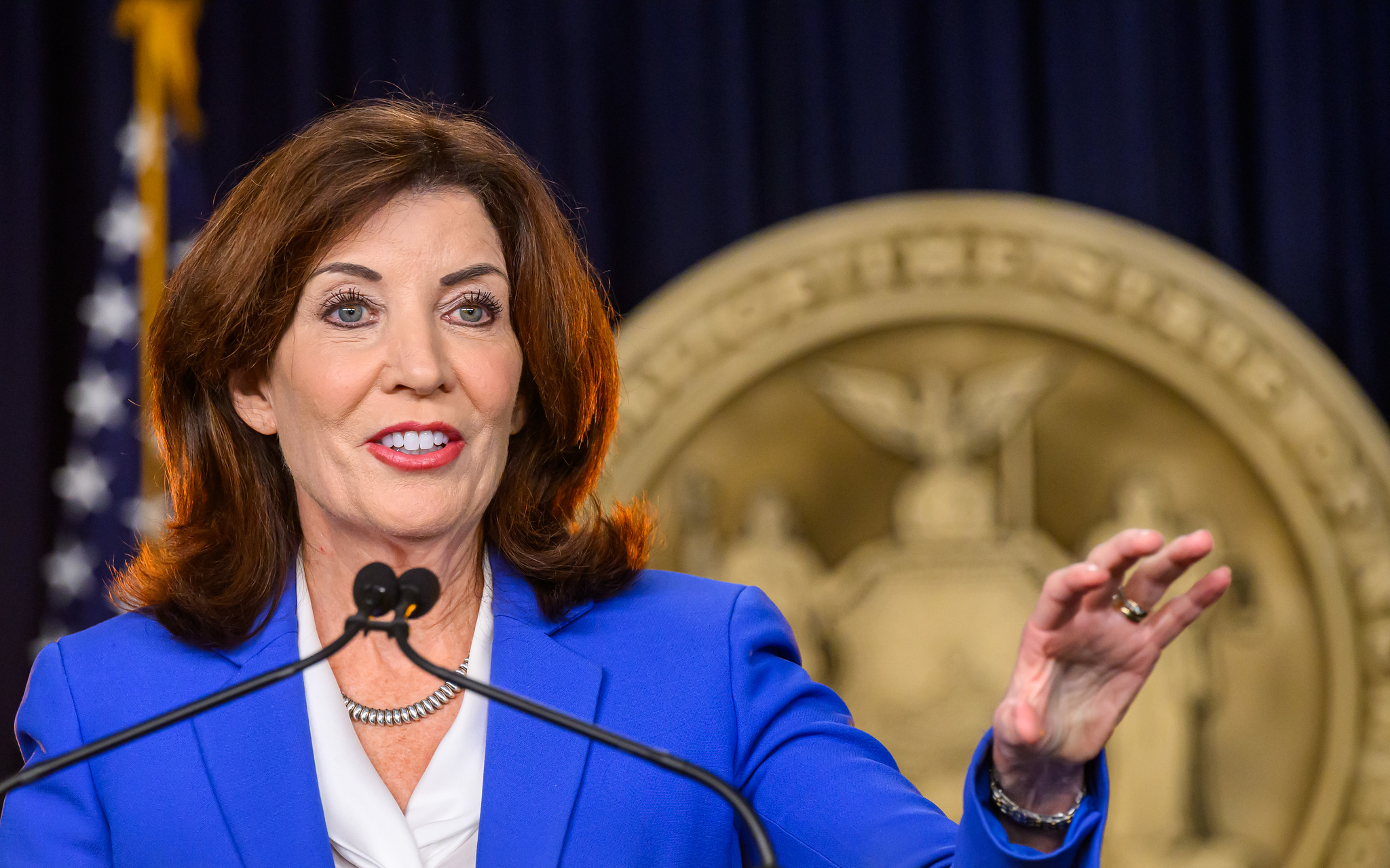 Gov. Kathy Hochul stands at a podium