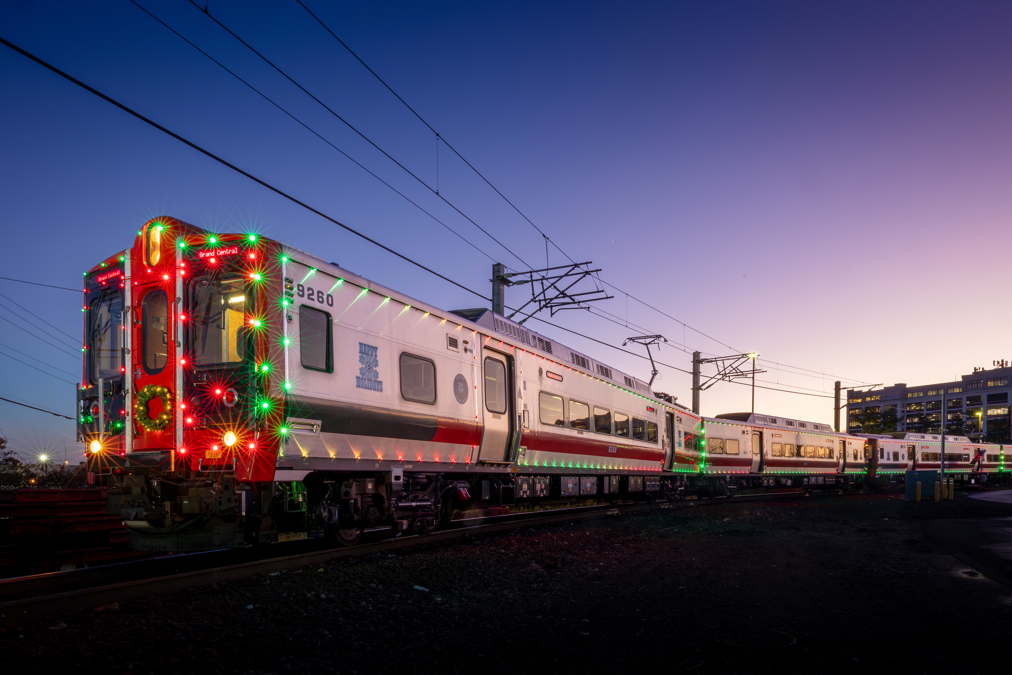 A Metro-North train covered in holiday lights.