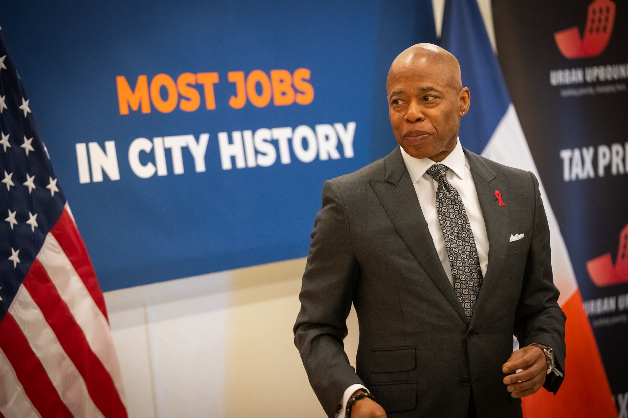 New York City Mayor Eric Adams against a blue background