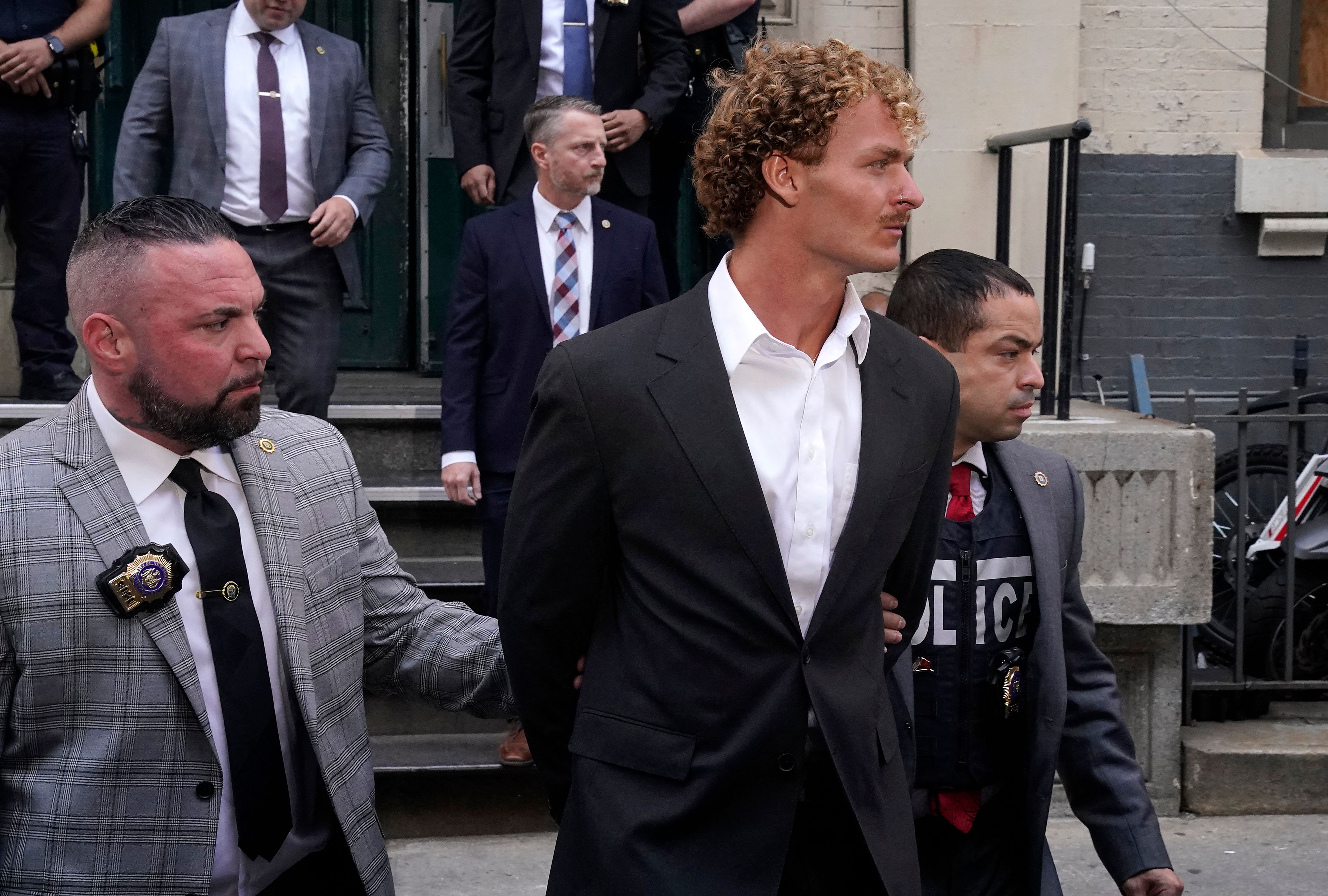 US Marine veteran Daniel Penny (C) is walked out of the New York Police Department 5th Precinct in Lower Manhattan, May 12, 2023.