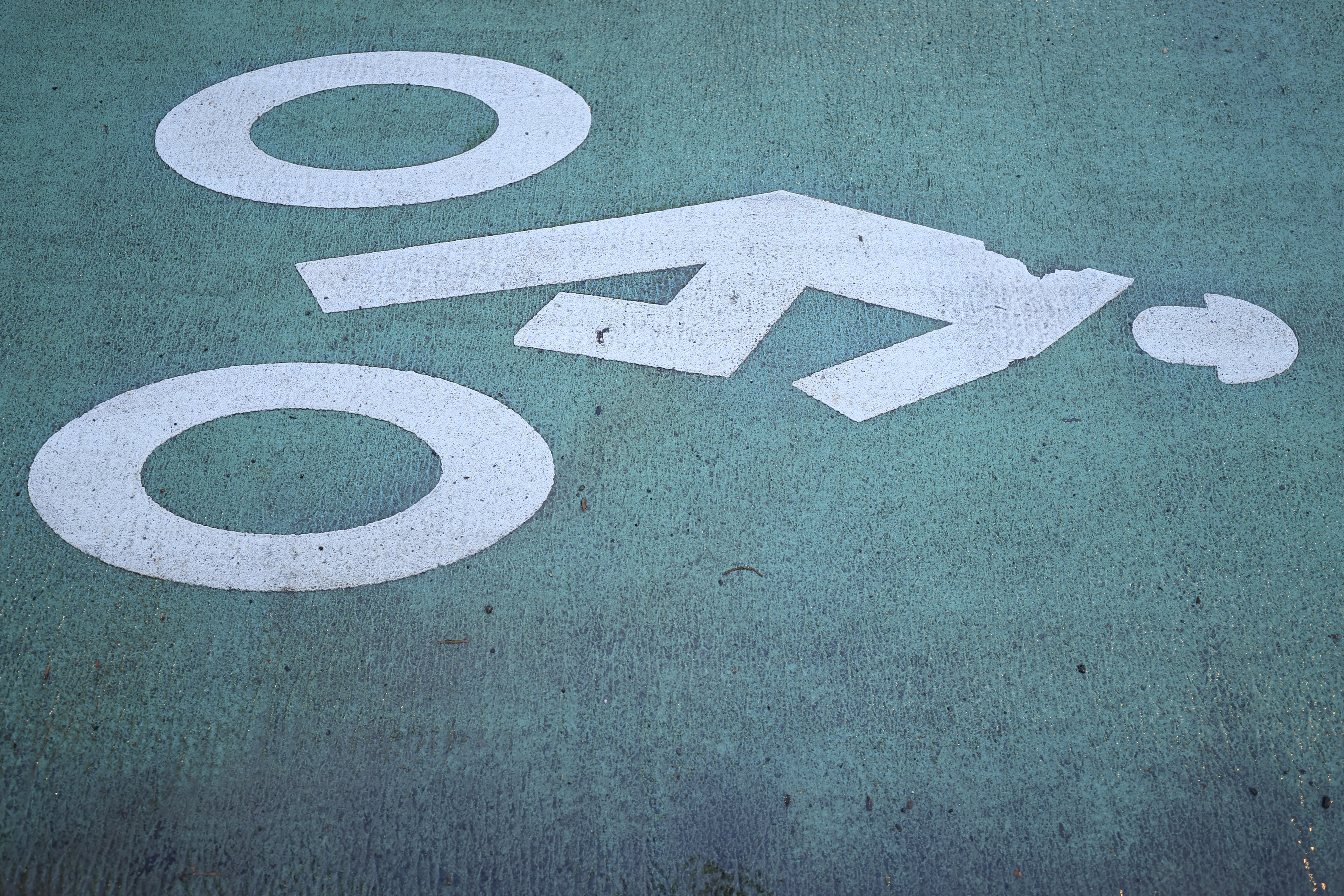 An NYC bike lane logo in the road.