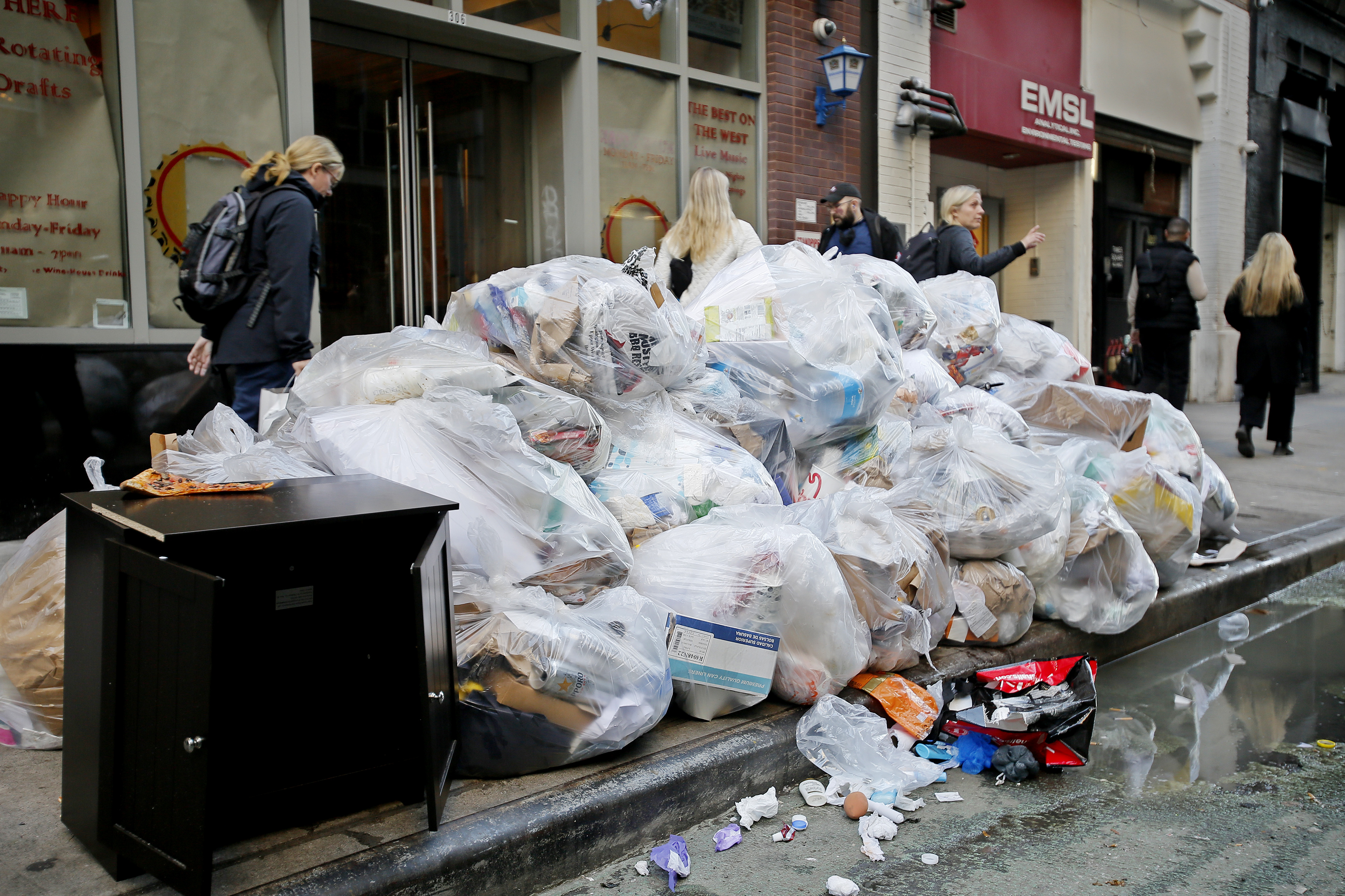 A pile of trash on a NYC sidewalk.