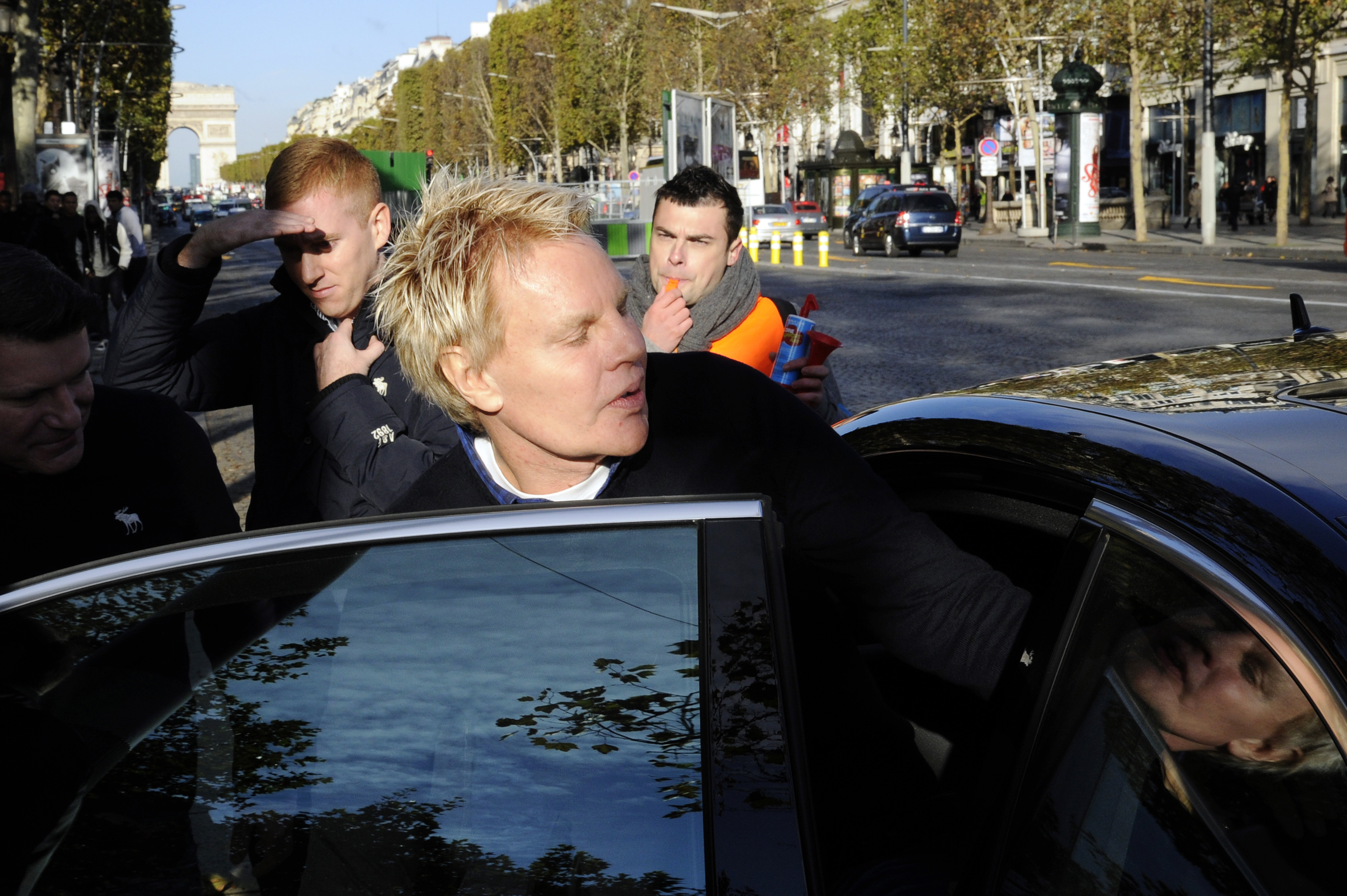 Mike Jeffries, CEO of clothing retailer Abercrombie & Fitch, leaves a store in Paris on Oct. 27, 2012, as some workers protest against their working conditions.