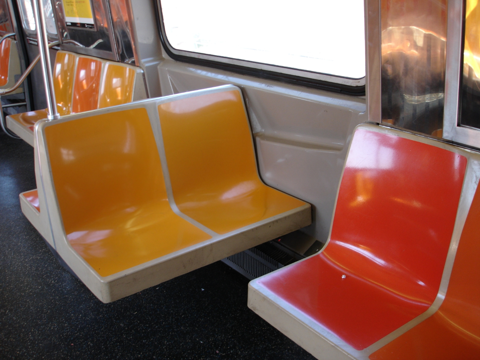 Orange and yellow seats on the subway.