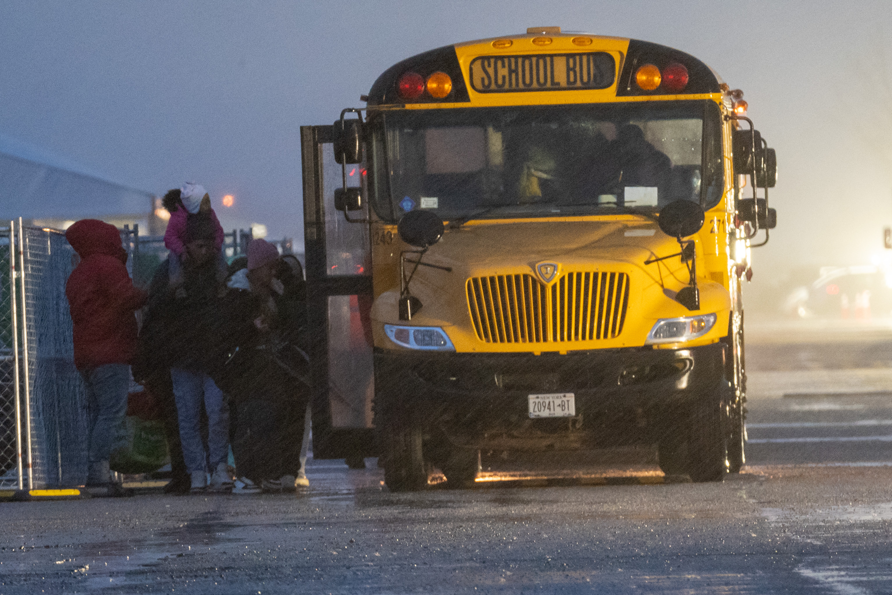 Migrants getting onto buses at the migrant shelter at Floyd Bennett Field in Brooklyn on Jan. 9, 2024.