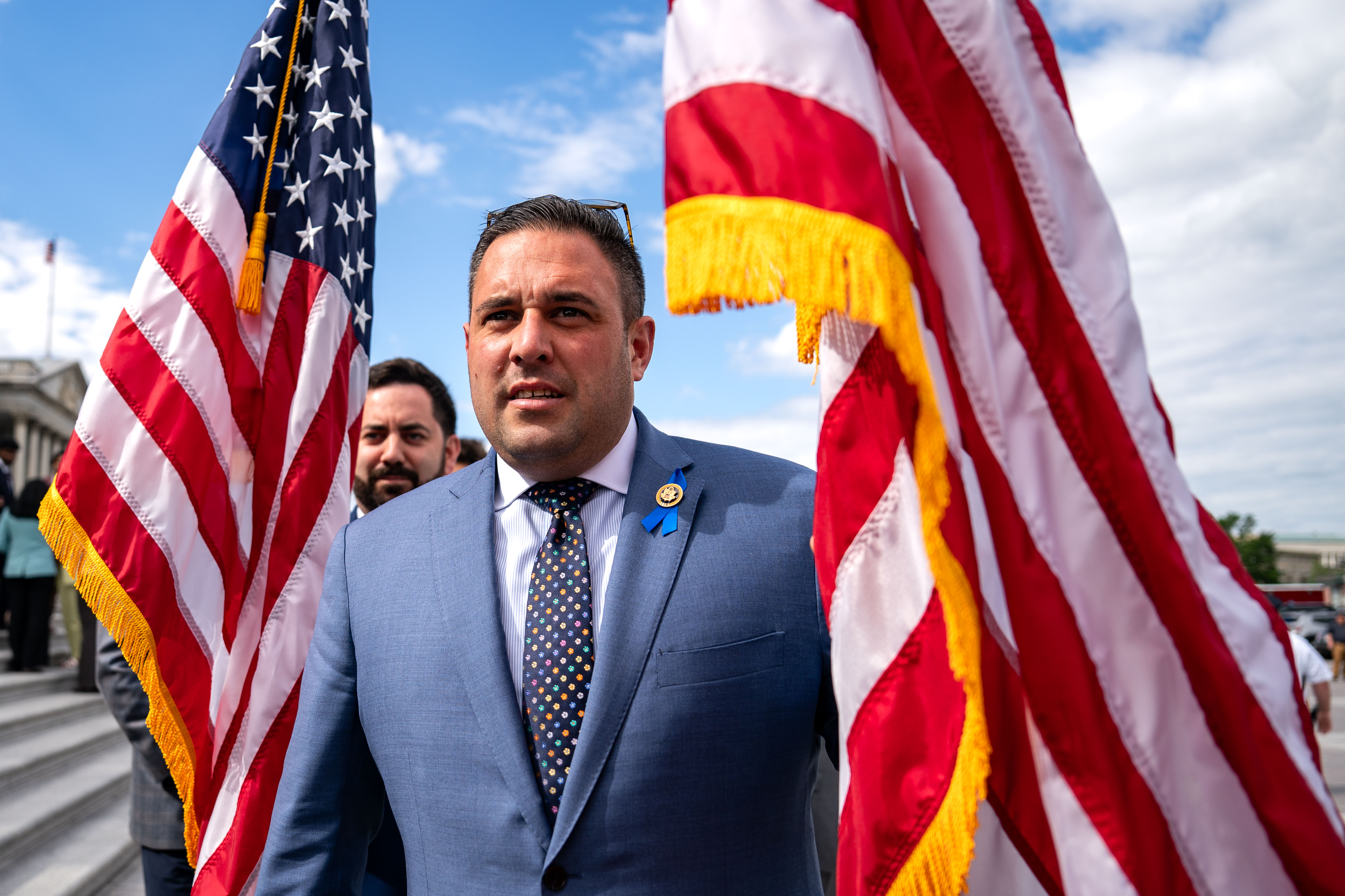 Two men carry American flags