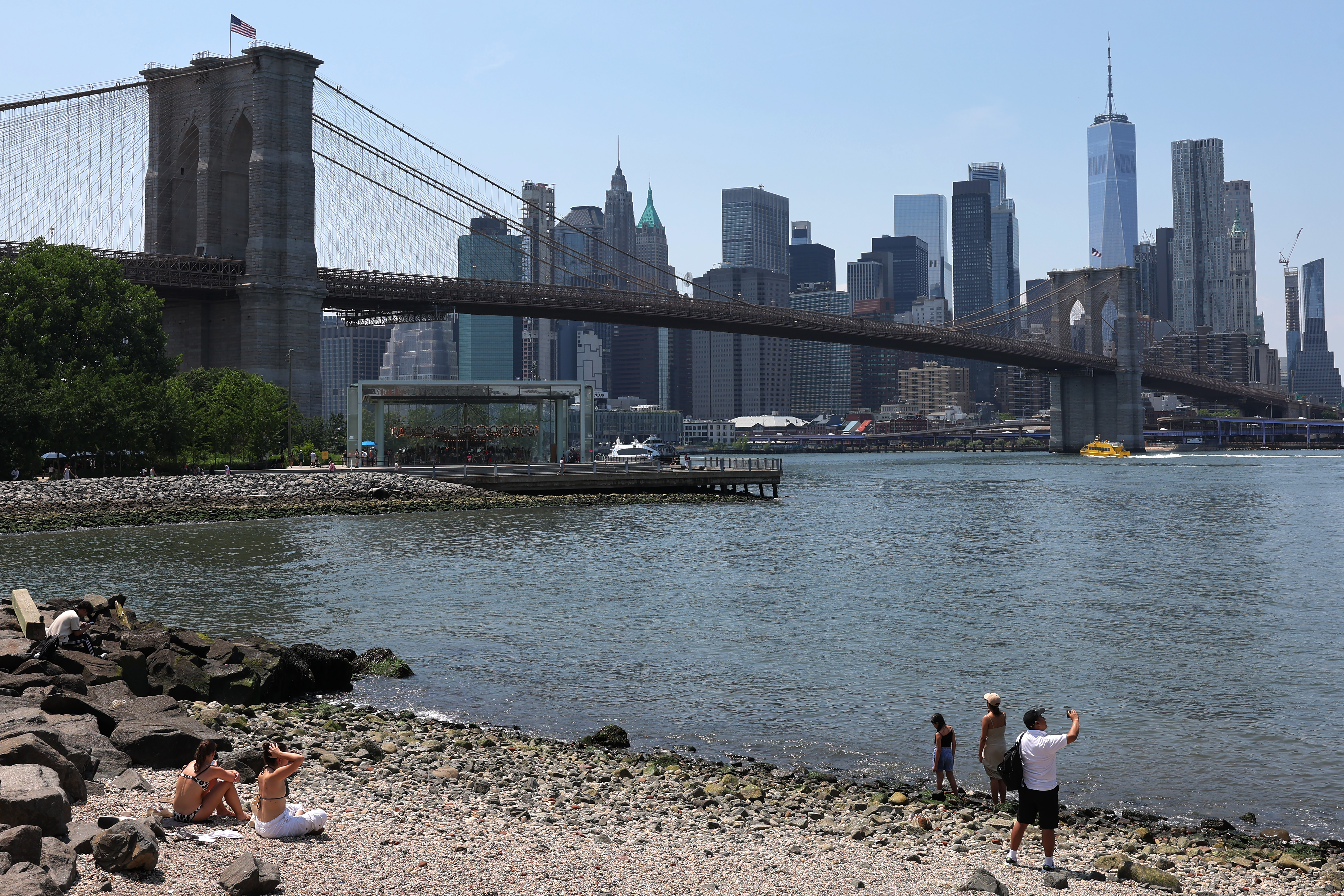 People are seen in Brooklyn Bridge Park on June 19, 2024.