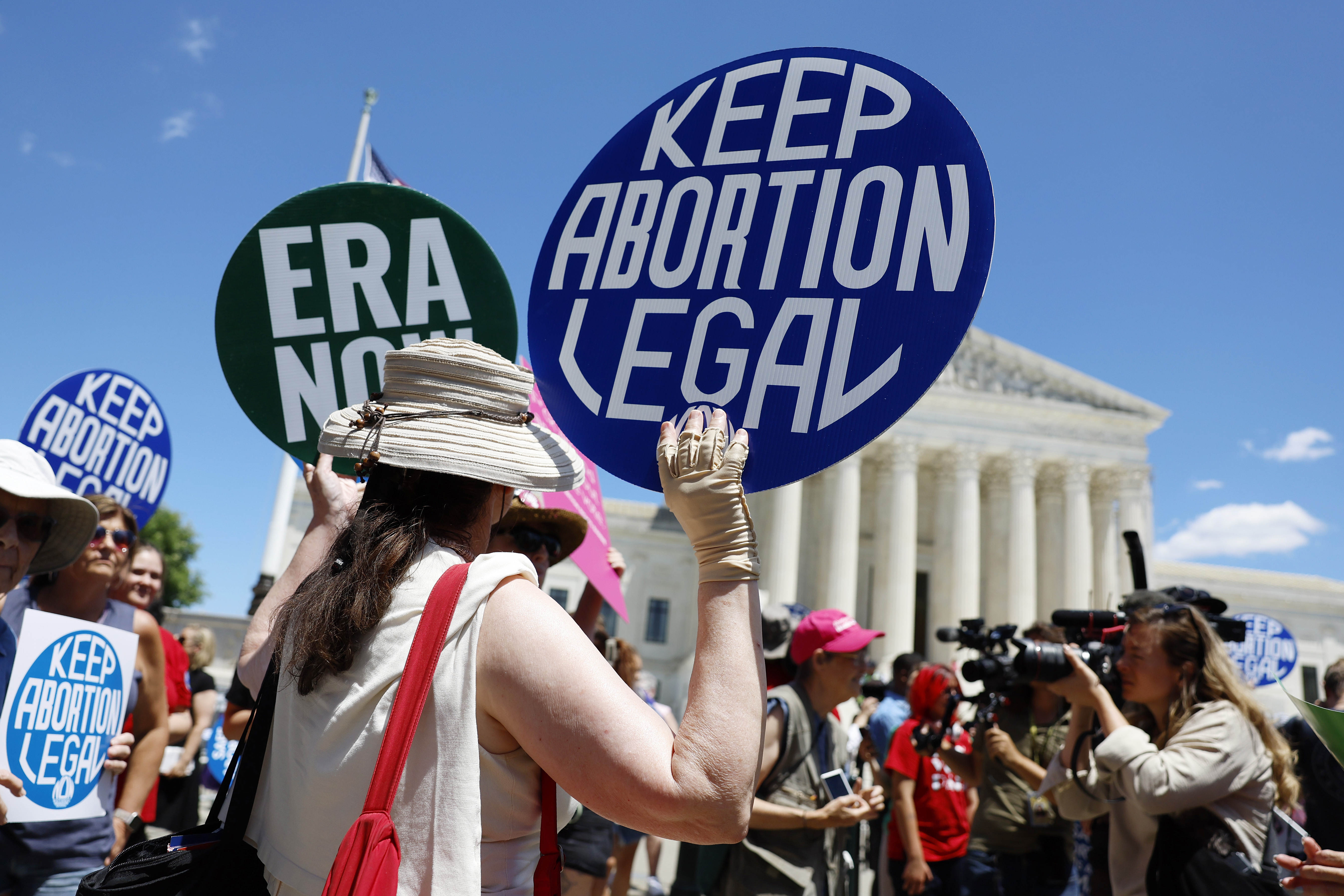 Protesters hold signs reading "KEEP ABORTION LEGAL" and "ERA NOW" outside the US Supreme Court