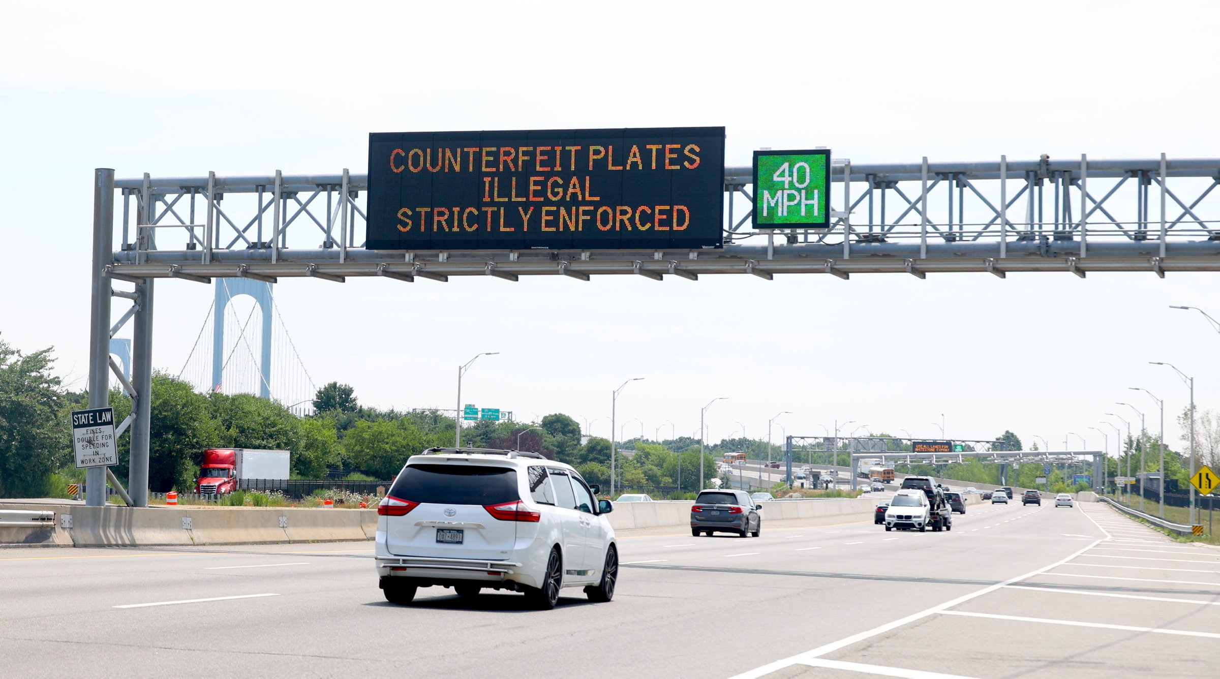 Road sign warns that counterfeit license plates are illegal Bronx, N.Y.