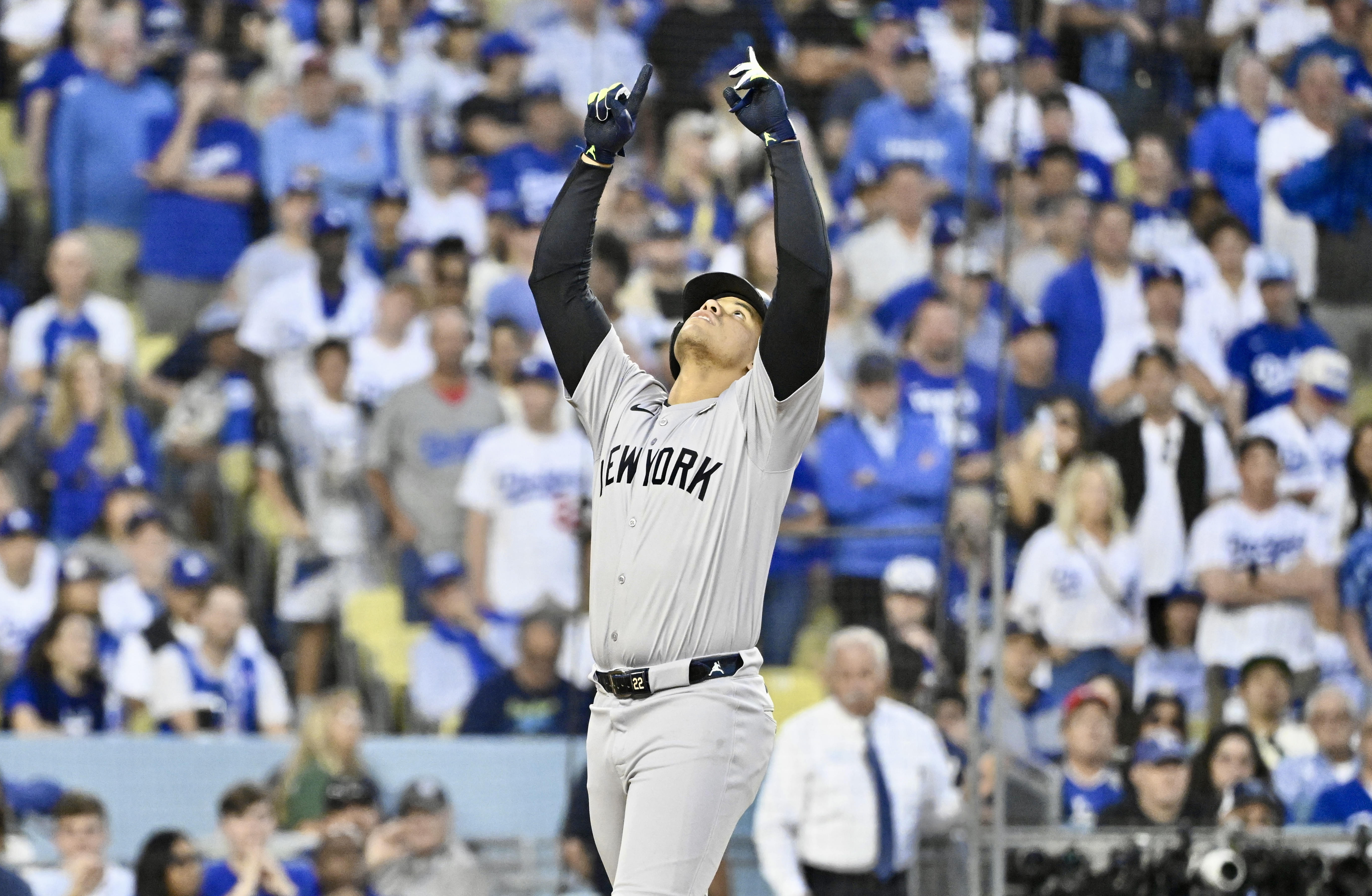 Juan Soto of the New York Yankees holds his hands up in the air, reacting after hitting a solo home run against the Los Angeles Dodgers in the third inning during Game 2 of the World Series.