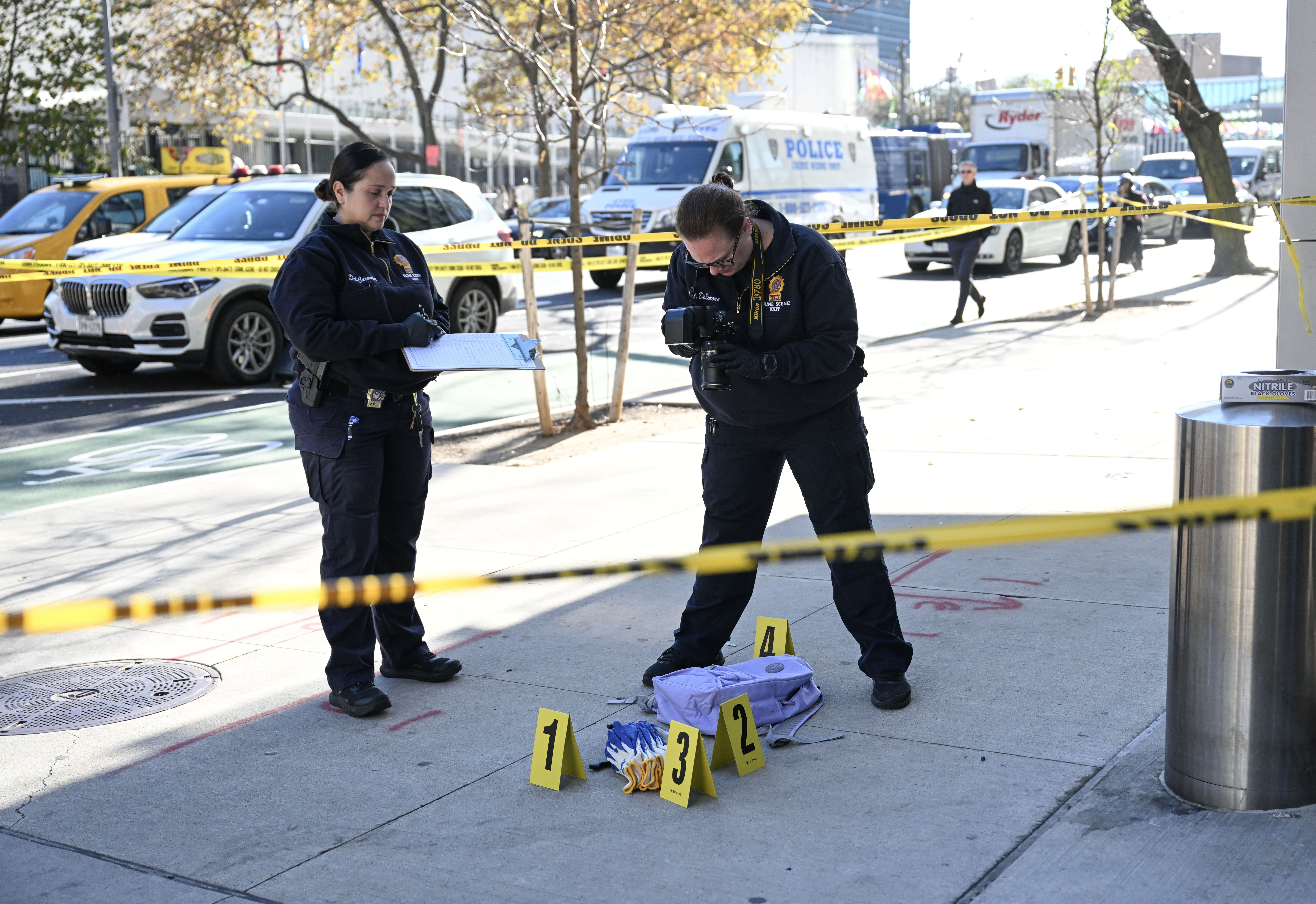 Police at East 46th Street and First Avenue investigate the site of one of the alleged stabbings in Manhattan that left three people dead on Nov. 18, 2024.