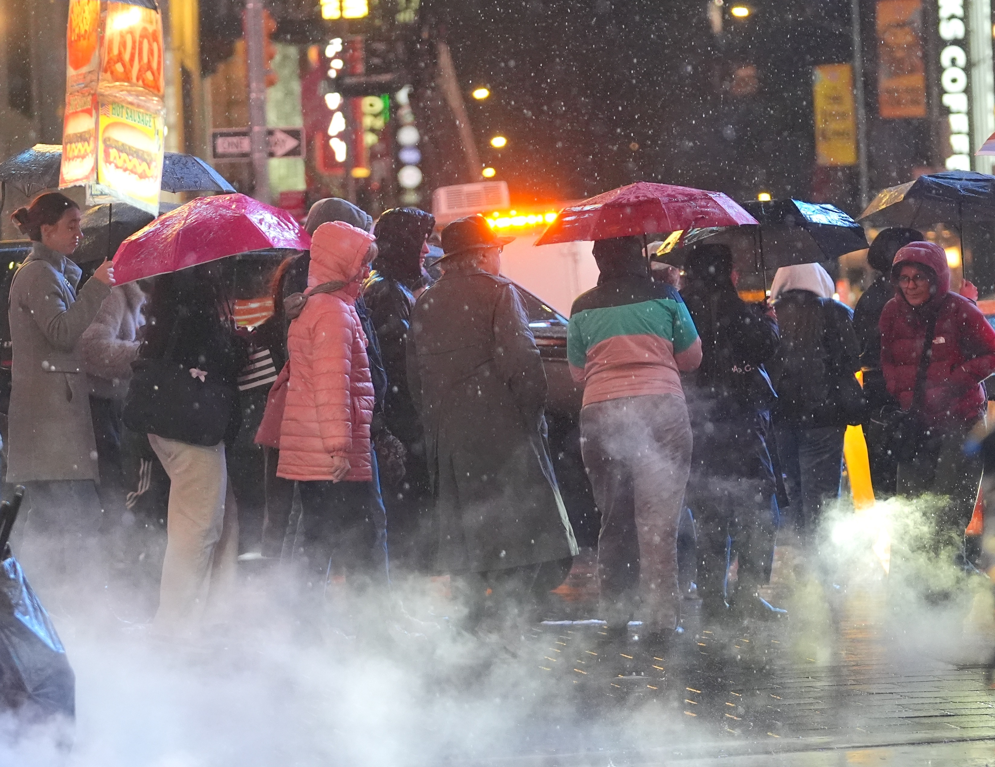 Pedestrians walk in the rain in New York City on Nov. 21, 2024.