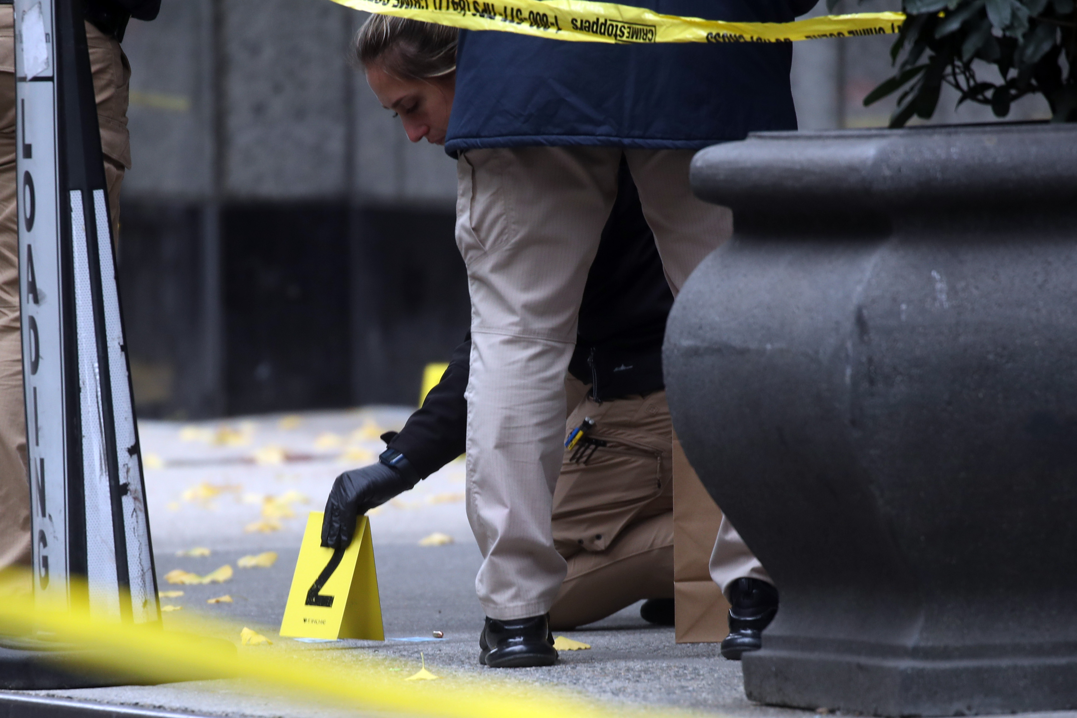 Police place bullet casing markers outside of a Hilton Hotel in Midtown Manhattan where United Healthcare CEO Brian Thompson was fatally shot on December 04, 2024 in New York City.