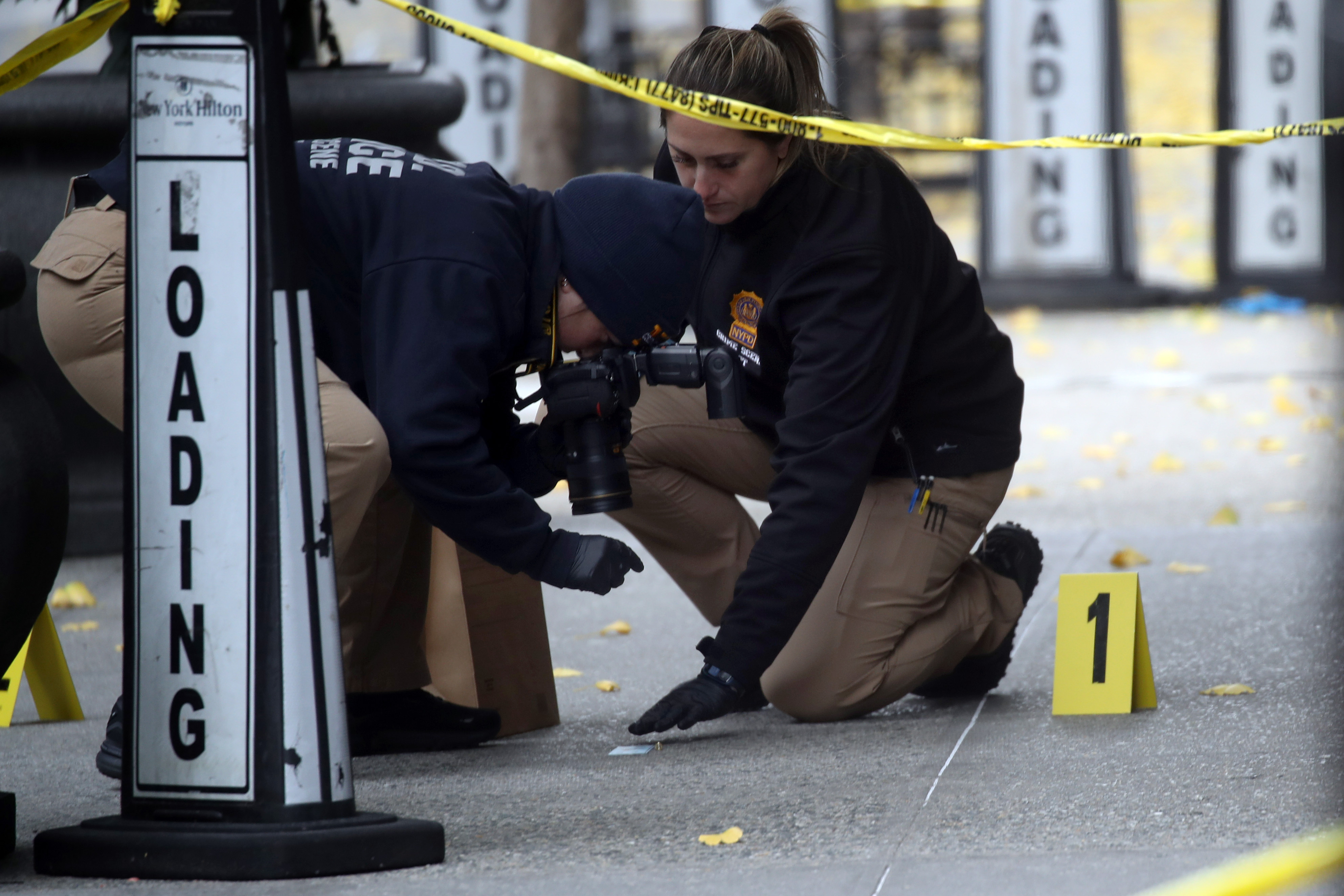 Police place bullet casing markers outside of a Hilton Hotel in Midtown Manhattan where United Healthcare CEO Brian Thompson was fatally shot on Dec. 4, 2024 in New York City.