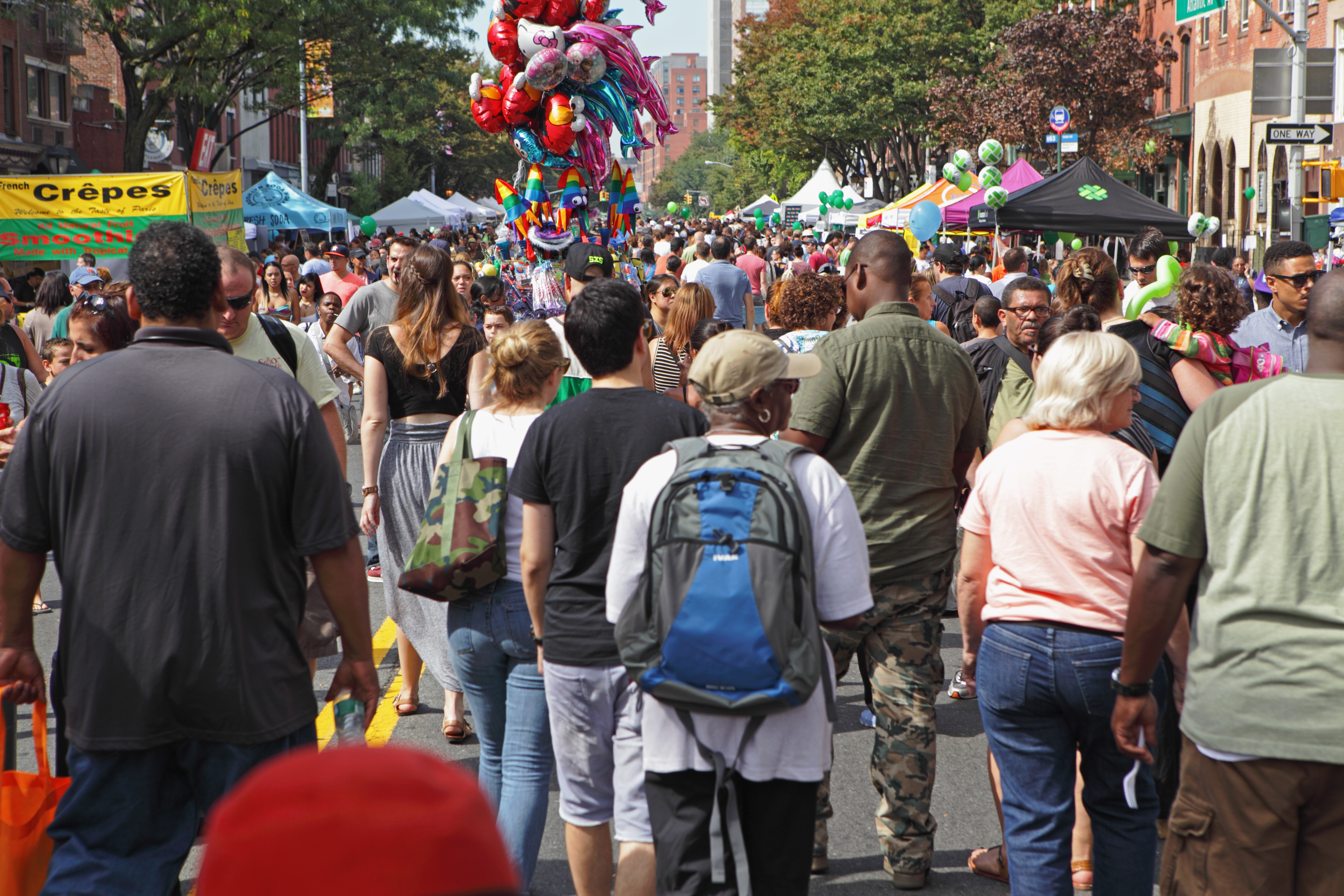 A large crowd at a street fair.