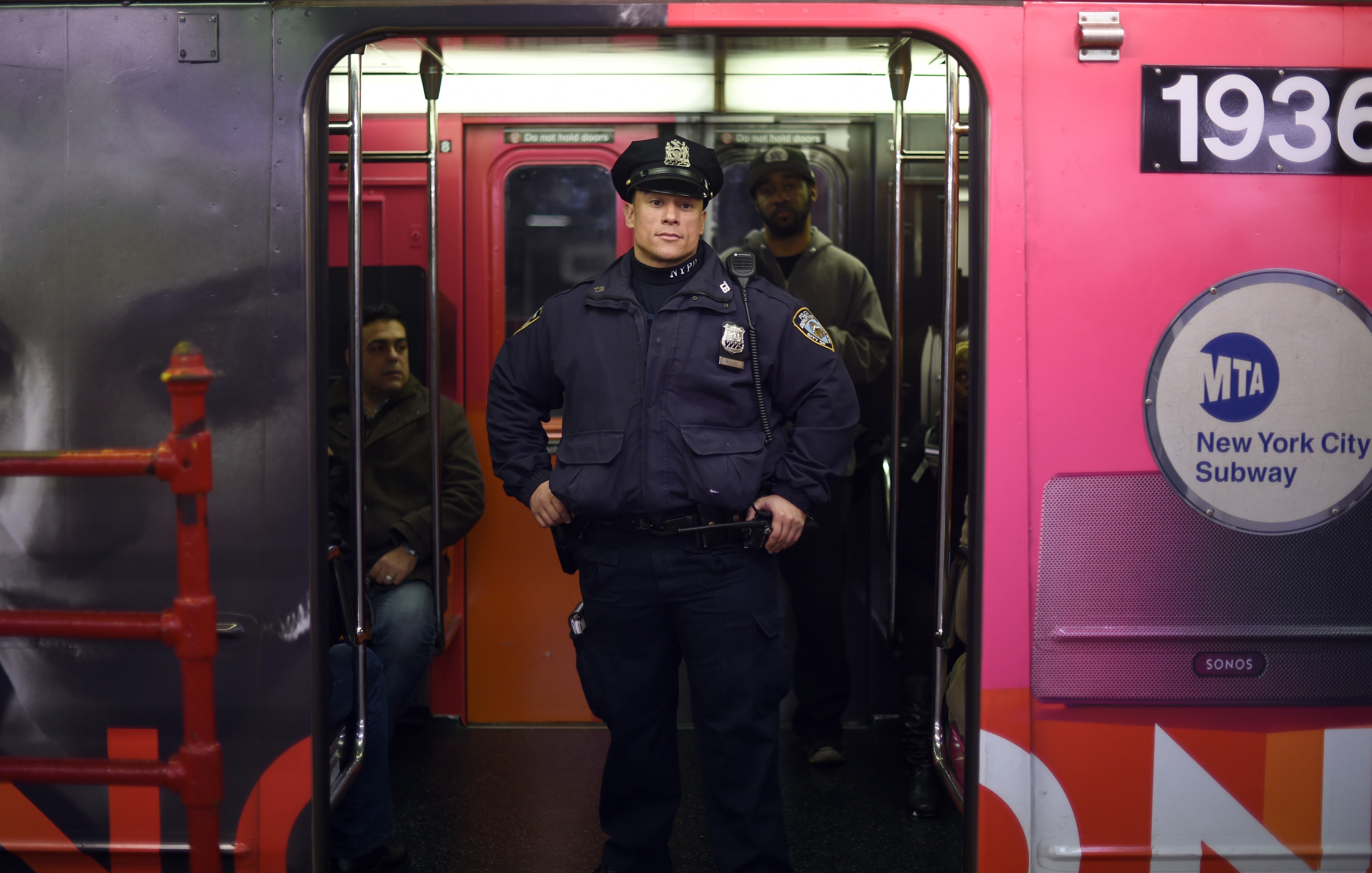 NYPD officers patrol the subway at Times Square in New York November 14, 2015, the morning after the attacks that killed at least 128 people in Paris.