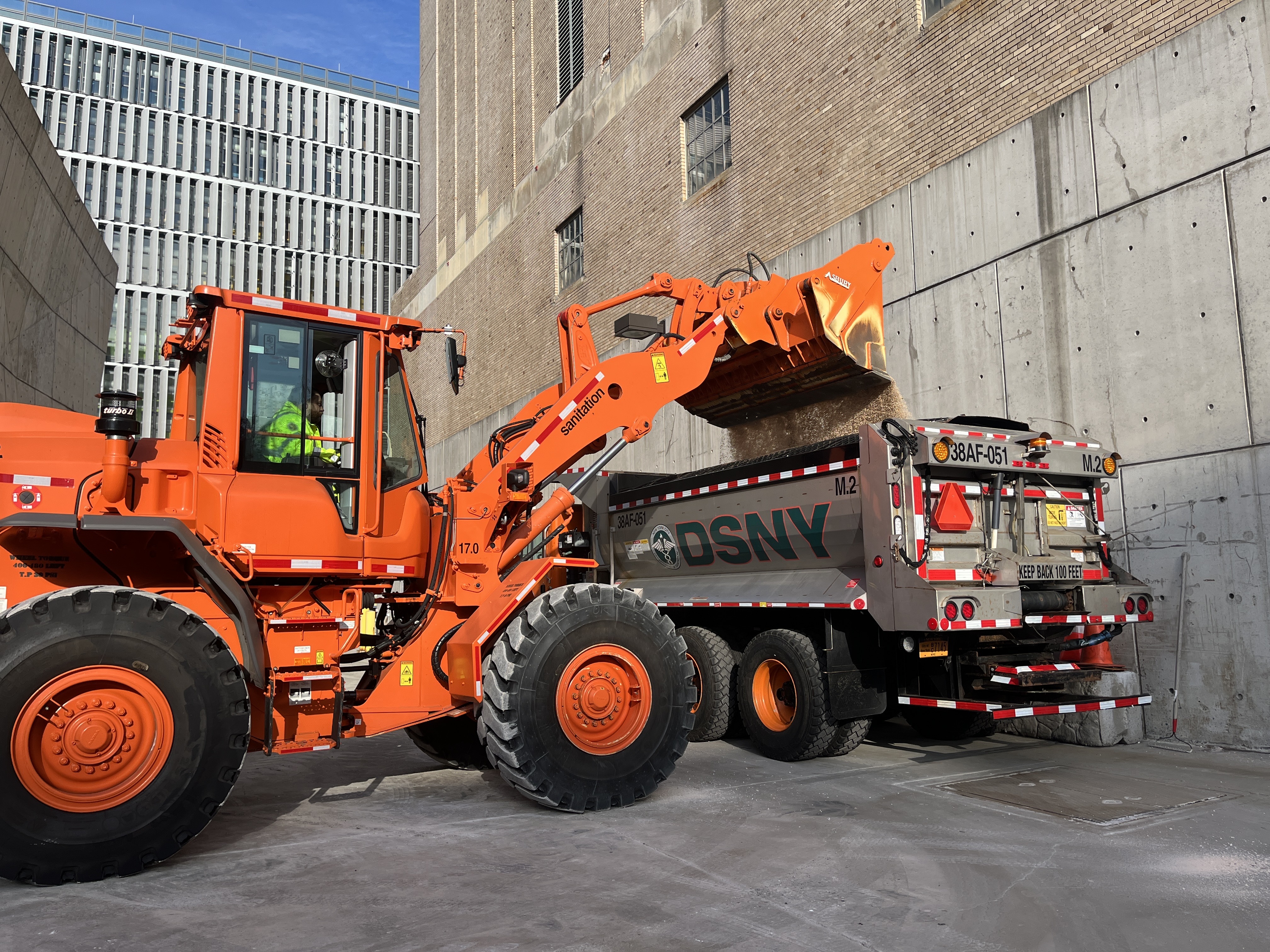 A bulldozer loading salt into a truck.