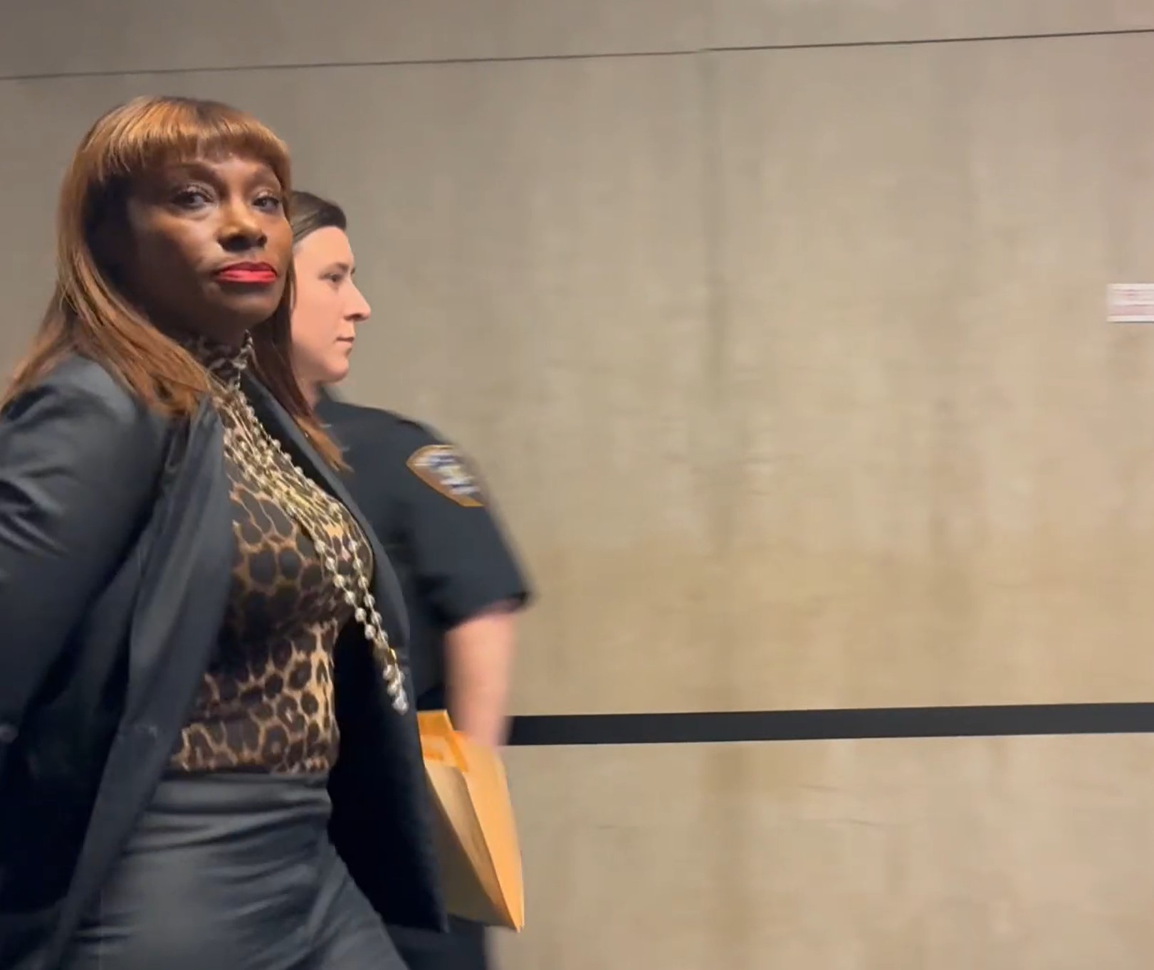 A photo of Adams adviser Ingrid Lewis-Martin being led to her arraignment in handcuffs.