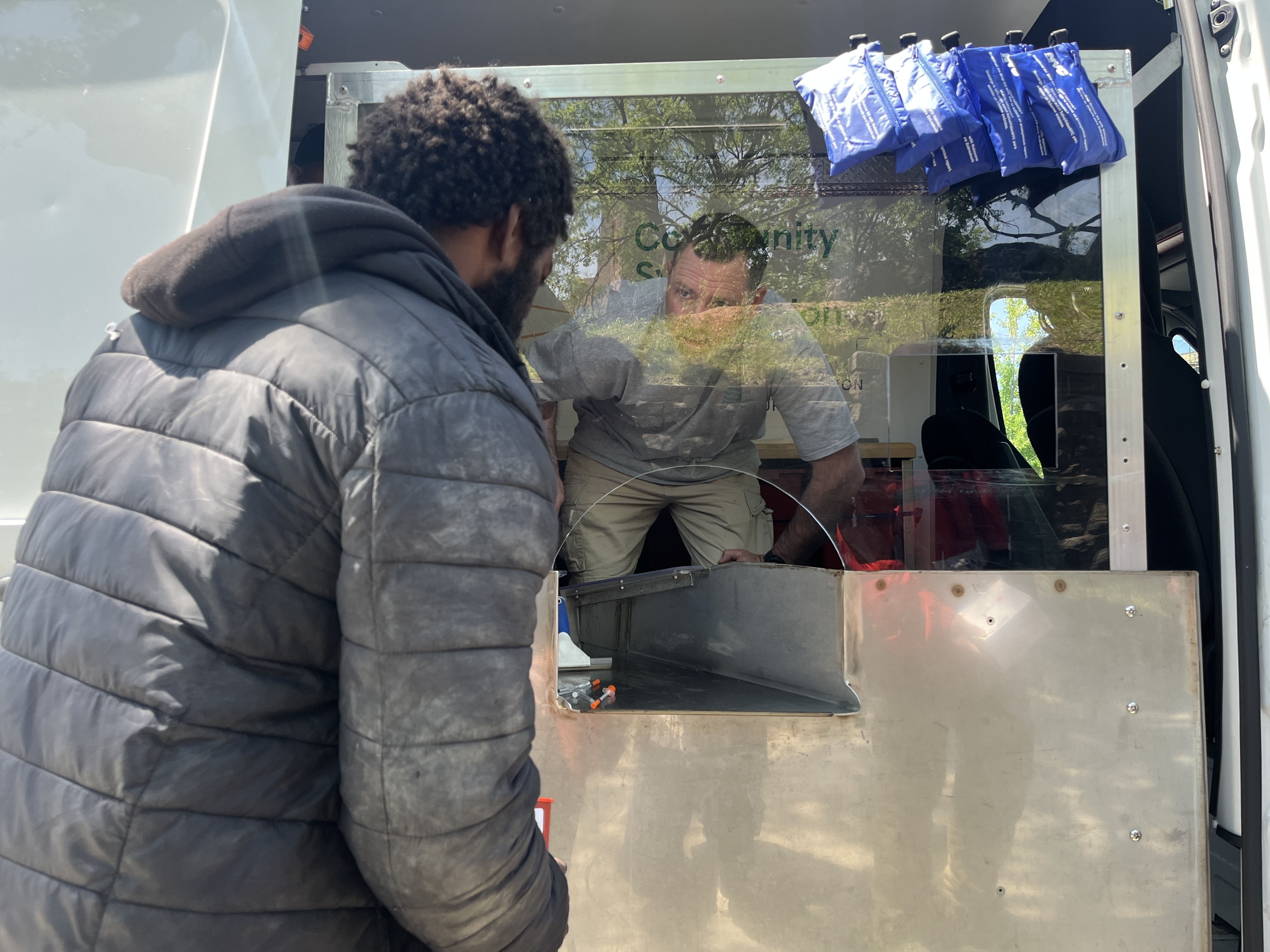 osh DeLisle, a cofounder of Addiction Response Resources, which operates the syringe buyback program, talks to a participant outside Echo Park in the Bronx.
